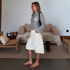 An influencer wearing clear wedges. 