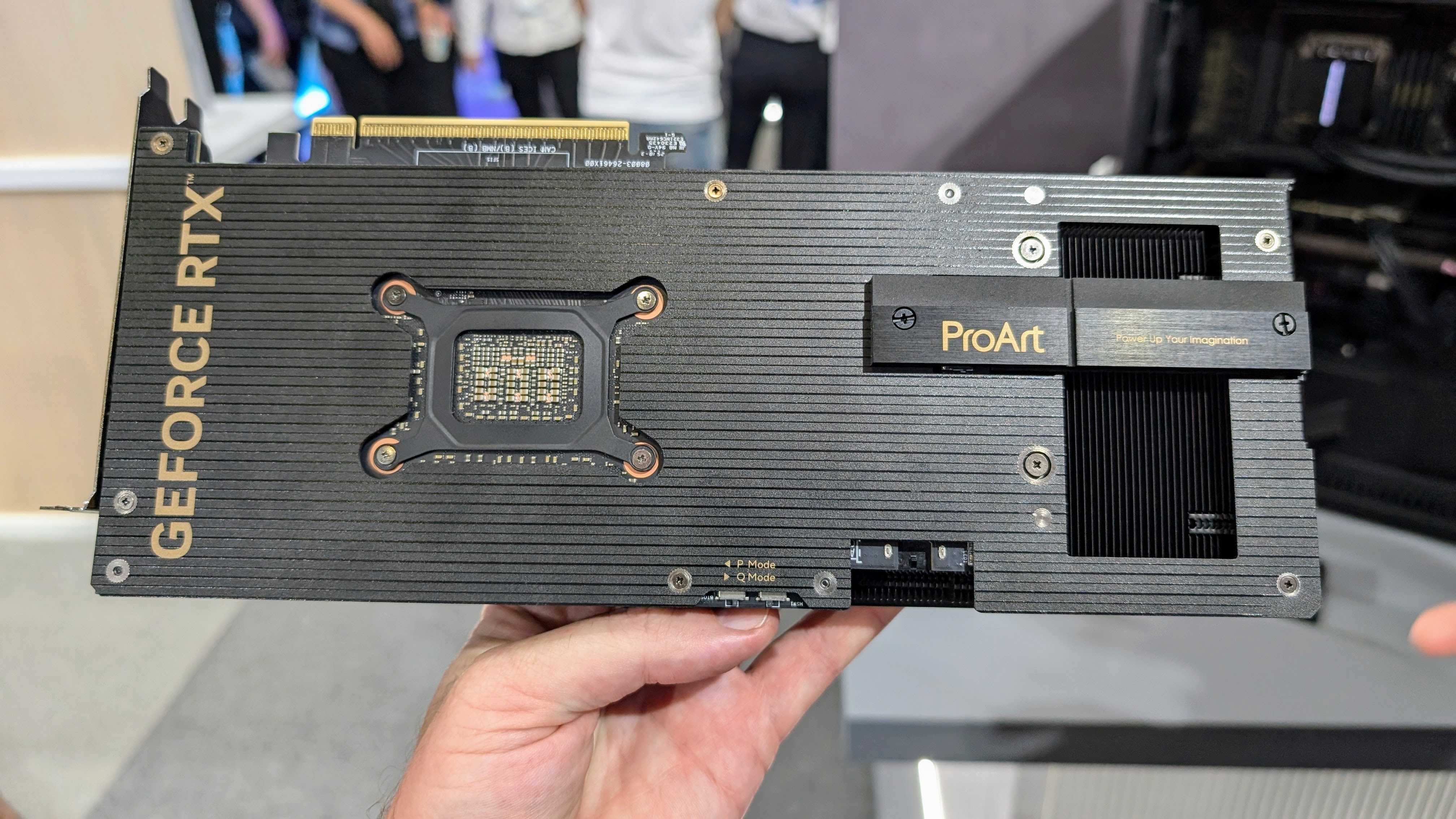 Asus ProArt GeForce RTX series GPU held in a hand showing the rear at Computex 2025