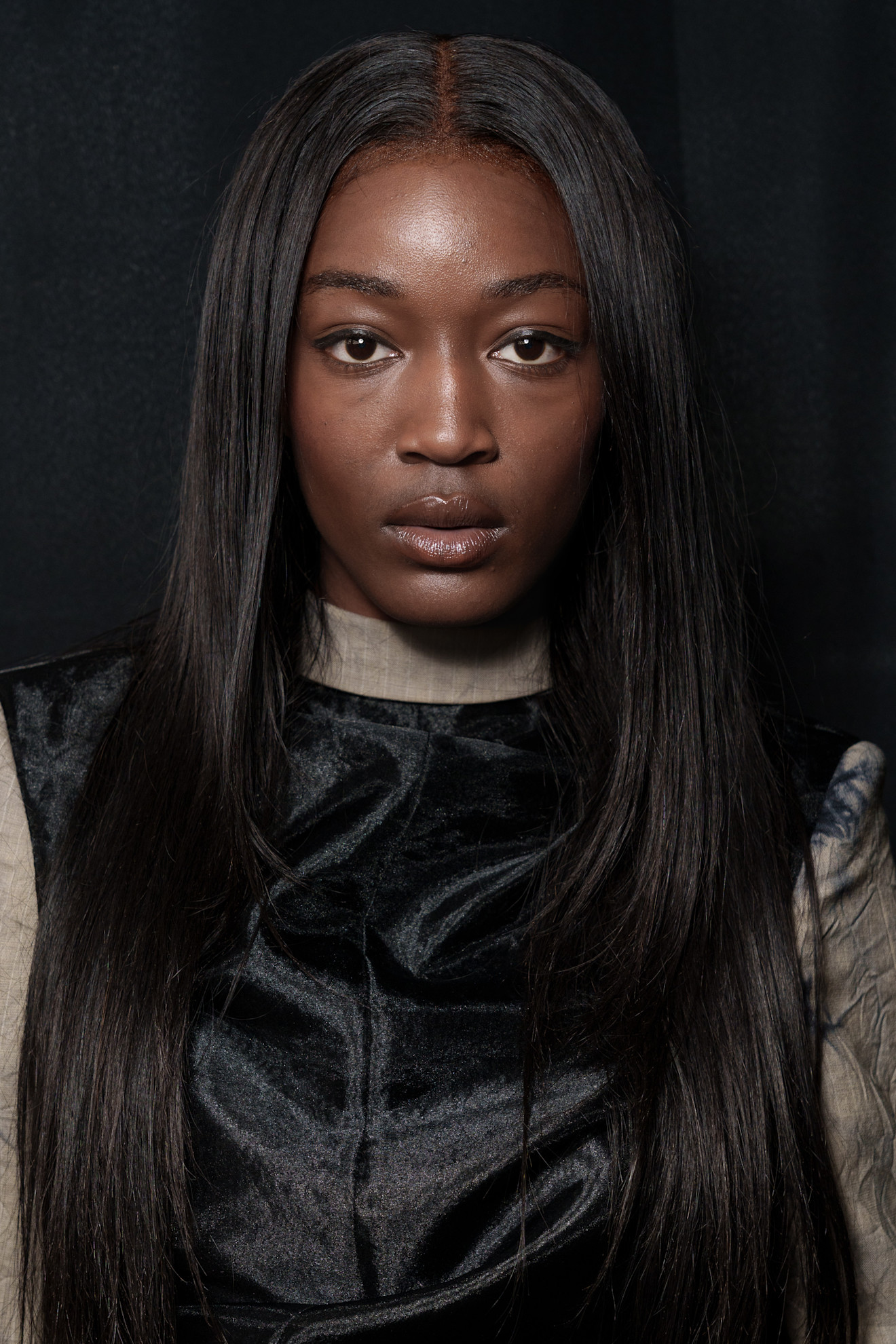 A model with their hair cut into a butterfly cut.