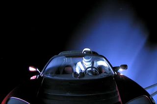 A Hot Wheels Tesla Roadster, complete with a tiny Starman, sits on the dashboard of Elon Musk’s Roadster after being launched into deep space.