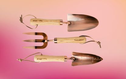 copper garden tools on a colorful background