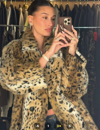 hailey bieber wears a cheetah coat and bikini on new year's eve 2024