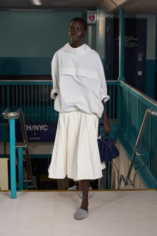 A model walks the Tommy Hilfiger runway wearing the high neckline trend.