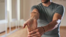 Man doing a forearm stretch.