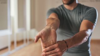 Man doing a forearm stretch.