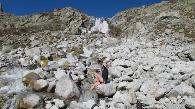Mary McConneloug soaks her ankle in a glacial river