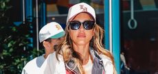 Jessica Alba wearing Gucci sunglasses and a baseball cap