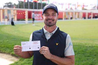 Brandon Robinson Thompson poses with his scorecard after shooting 61 at the 2025 Bahrain Championship