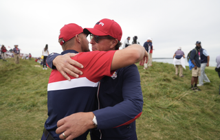 Bryson DeChambeau and Phil Mickelson hug