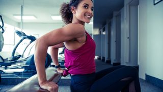 Woman doing tricep dips in gym