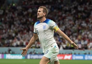 Harry Kane celebrates after scoring for England against Senegal at the 2022 World Cup.