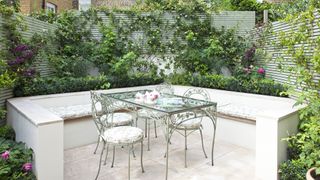 Patio seating area surrounded by horizontal trellis fencing