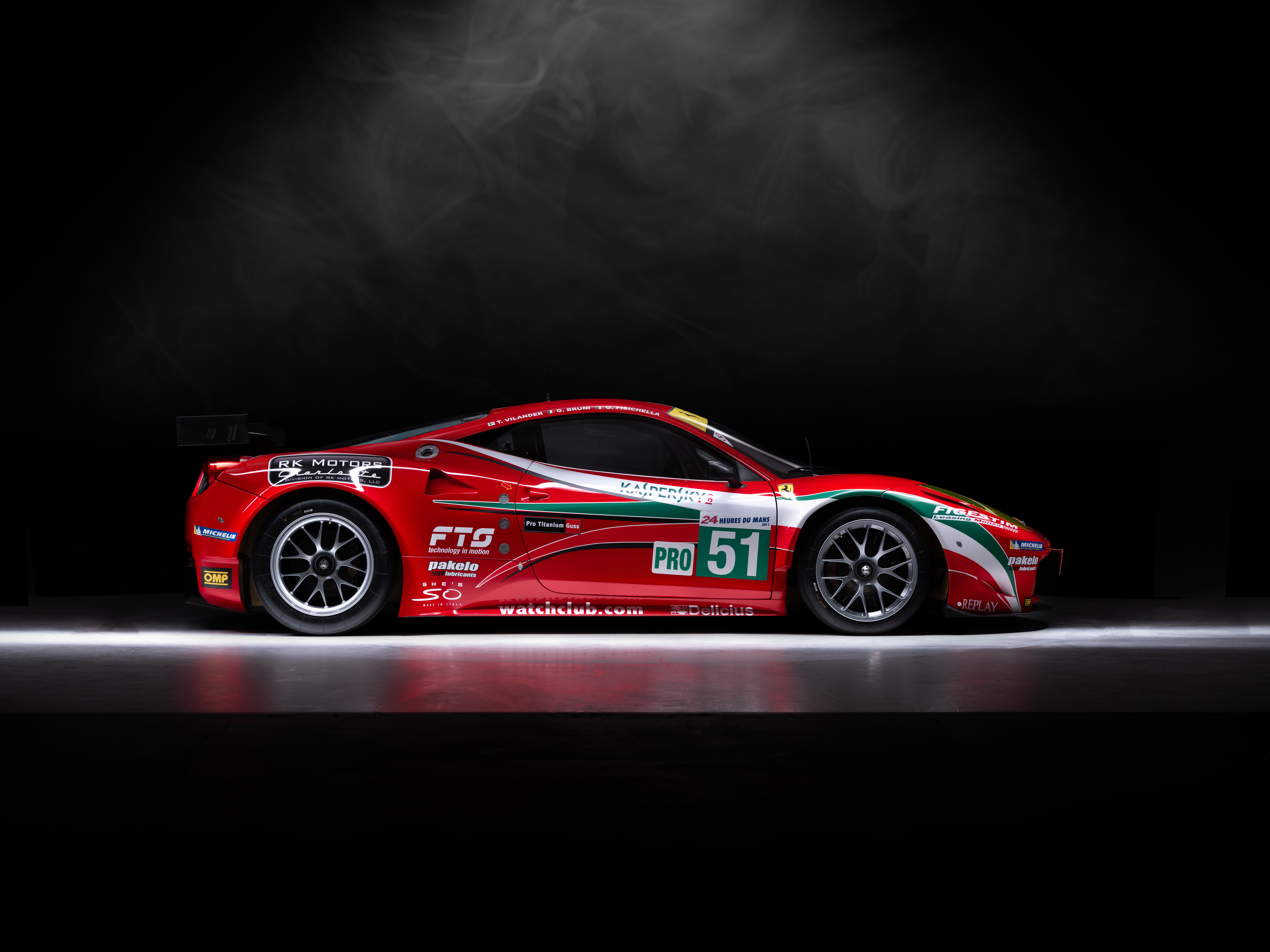 A red Ferrari 458 car in a studio