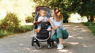 a photo of a woman and her baby with a stroller