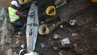 Archaeologists works at an excavation site in Wales. 