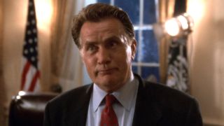 President Bartlet smiles confidently in the Oval Office in The West Wing episode "A Proportional Response."