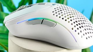 A white Glorious Model D2 wireless gaming mouse with a perforated design