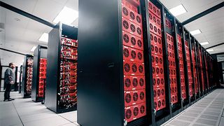 Inside a datacenter: red racks in black server mountings.