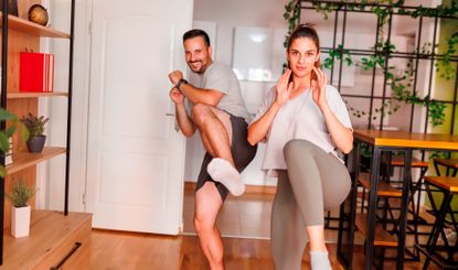 Man and woman in a home kicking towards the camera