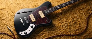 An Orangewood Del Sol Baritone lying on a yellow rug