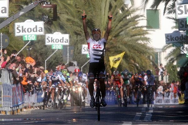 Cancellara raises his arms in a victory salute.