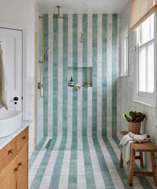 striped blue and white shower with wooden vanity unit and rattan blind