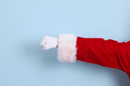 Hand of a man wearing santa claus costume 