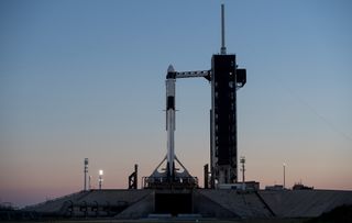 A SpaceX Falcon 9 rocket topped with the Crew Dragon spacecraft stands vertical on the launchpad at NASA's Kennedy Space Center in Florida ahead of its planned launch to the International Space Station. The capsule will make its first test flight on Saturday (March 2) at 2:49 a.m. EST (0749 GMT).