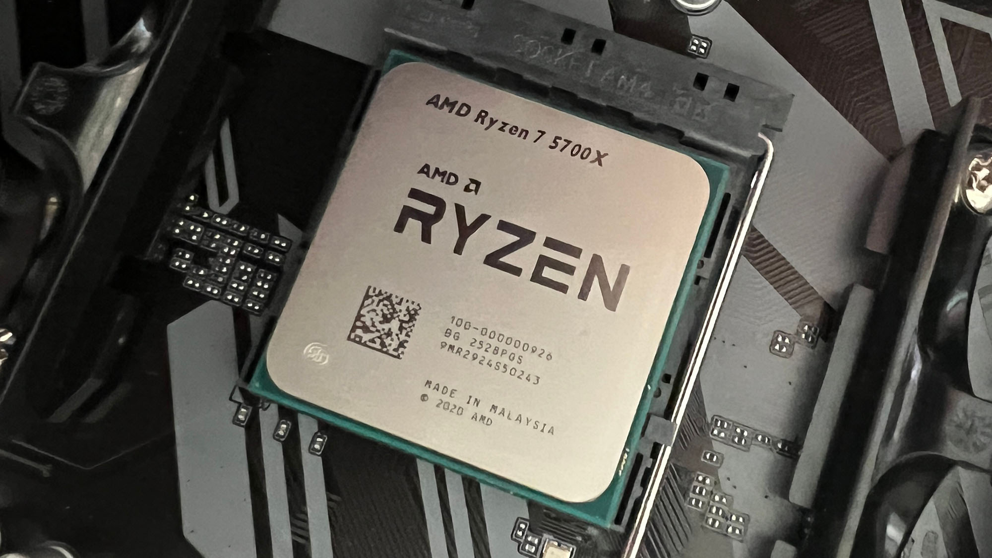 An AMD Ryzen 7 5700X slotted into a motherboard socket