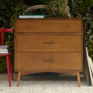 West Elm Mid-Century 3 Drawer Chest on a cream rug in front of foliage