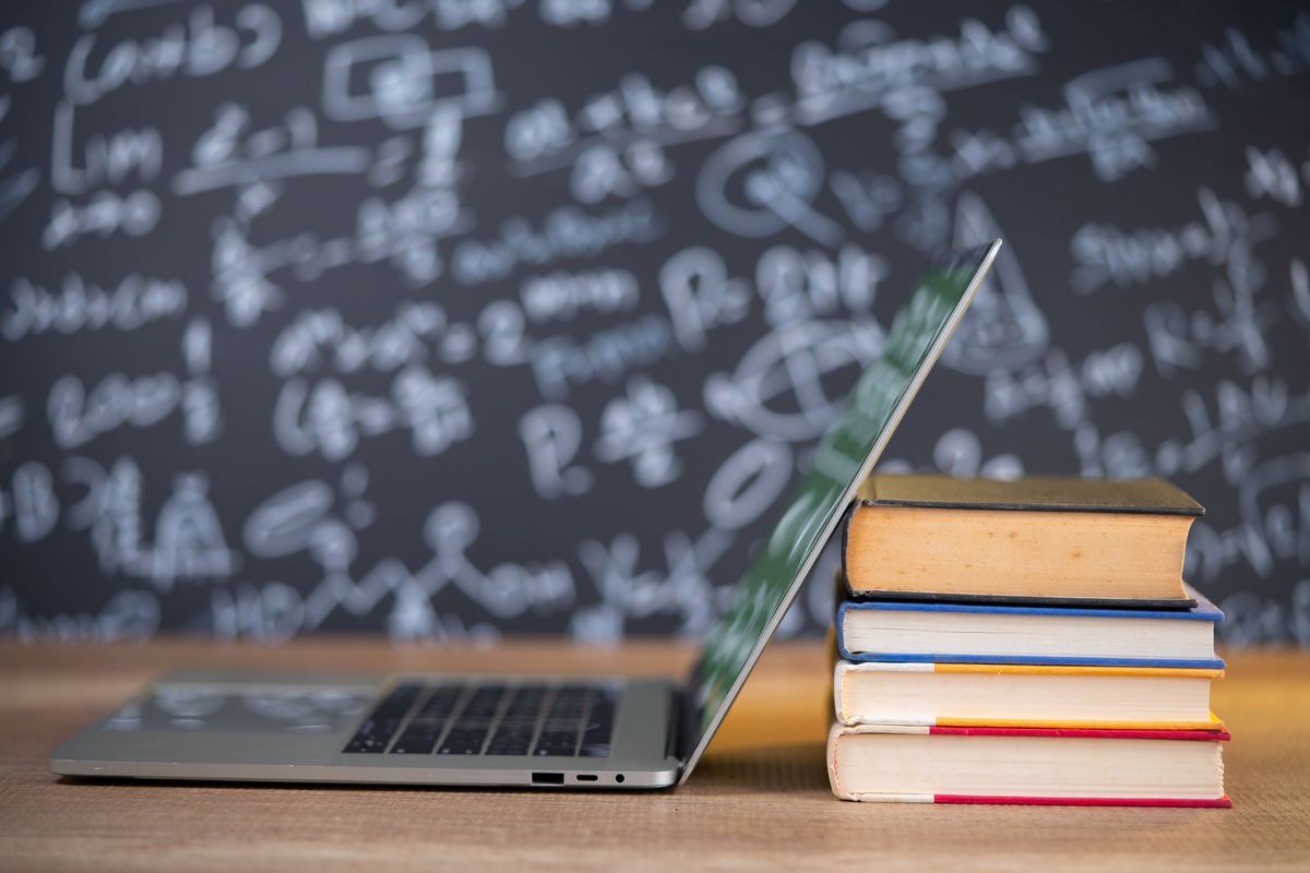 Books and laptop placed on a schooldesk