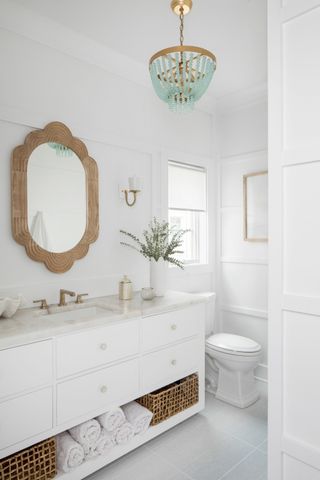 White boho style bathroom with blue chandelier