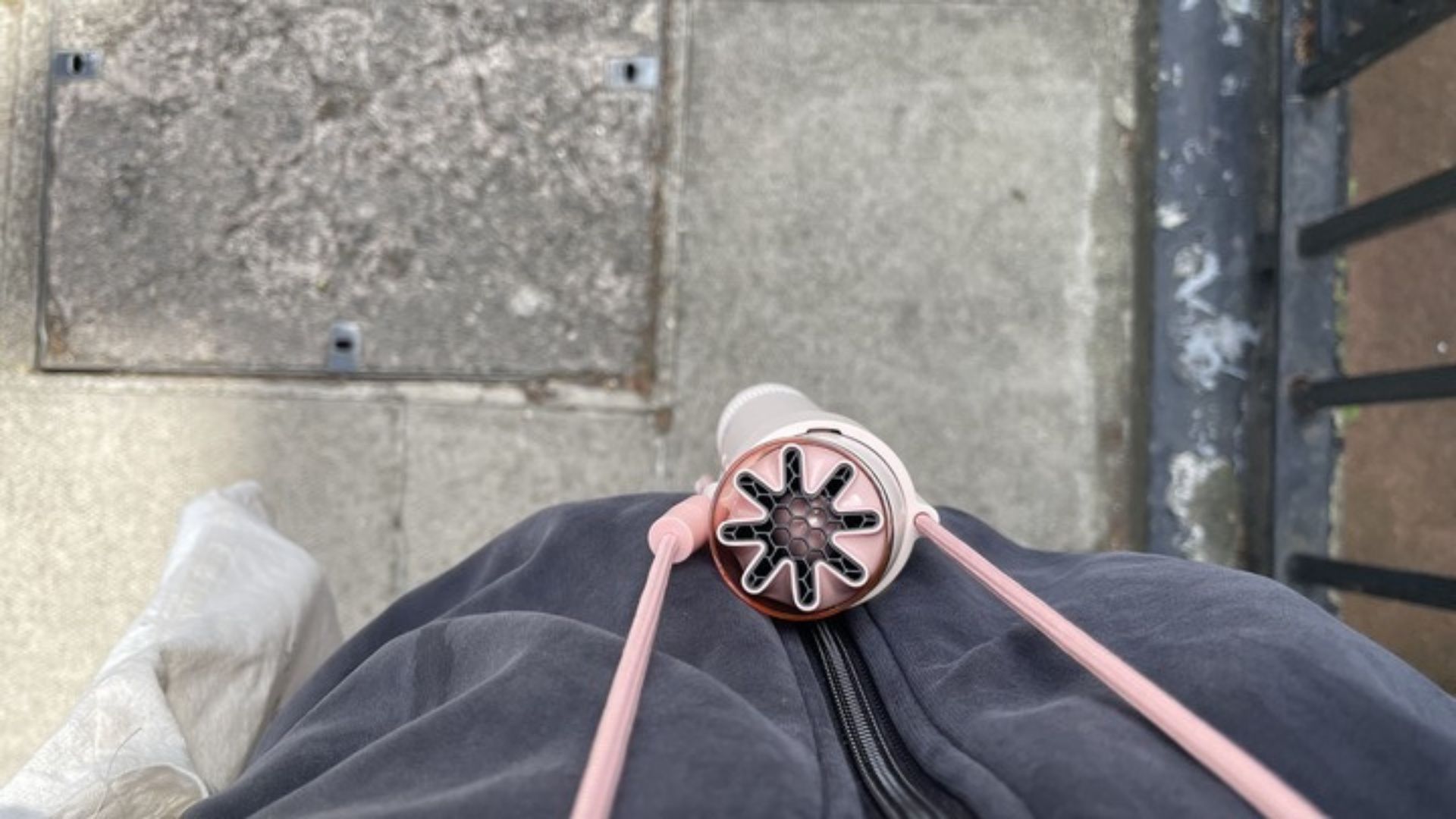 The Dyson HushJet Mini Cool Fan hanging around a neck