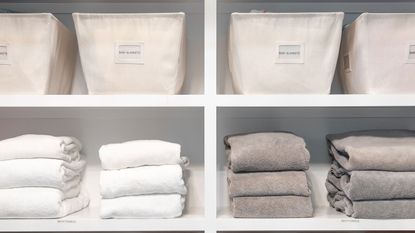Organized linens and towels on box shelves