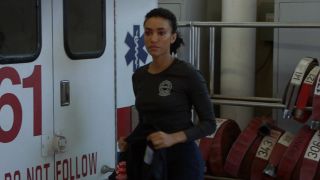 Annie Ilonzeh as Emily Foster standing by Ambulance 61 on Chicago Fire.