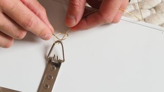 putting up a picture frame with wire