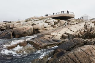 Wooden constructed walkway about rocky ground and water