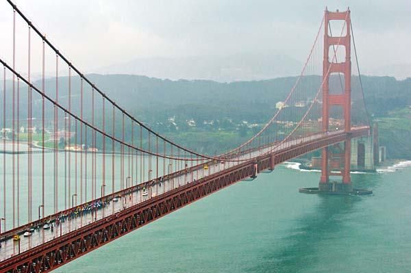 2009 Tour of California: Rain and fog enshroud the Golden Gate Bridge as the peloton crosses