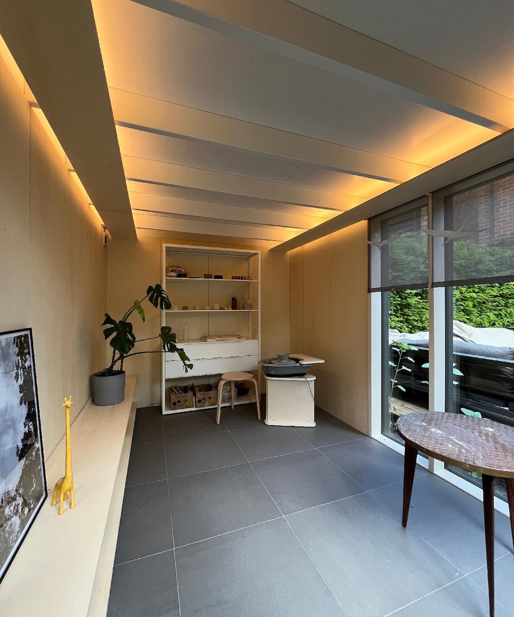 Inside a shed with a small bookshelf and ledge for sitting on