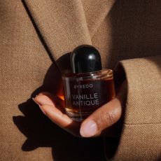 Hand holding bottle of Byredo Vanille Antique perfume extrait